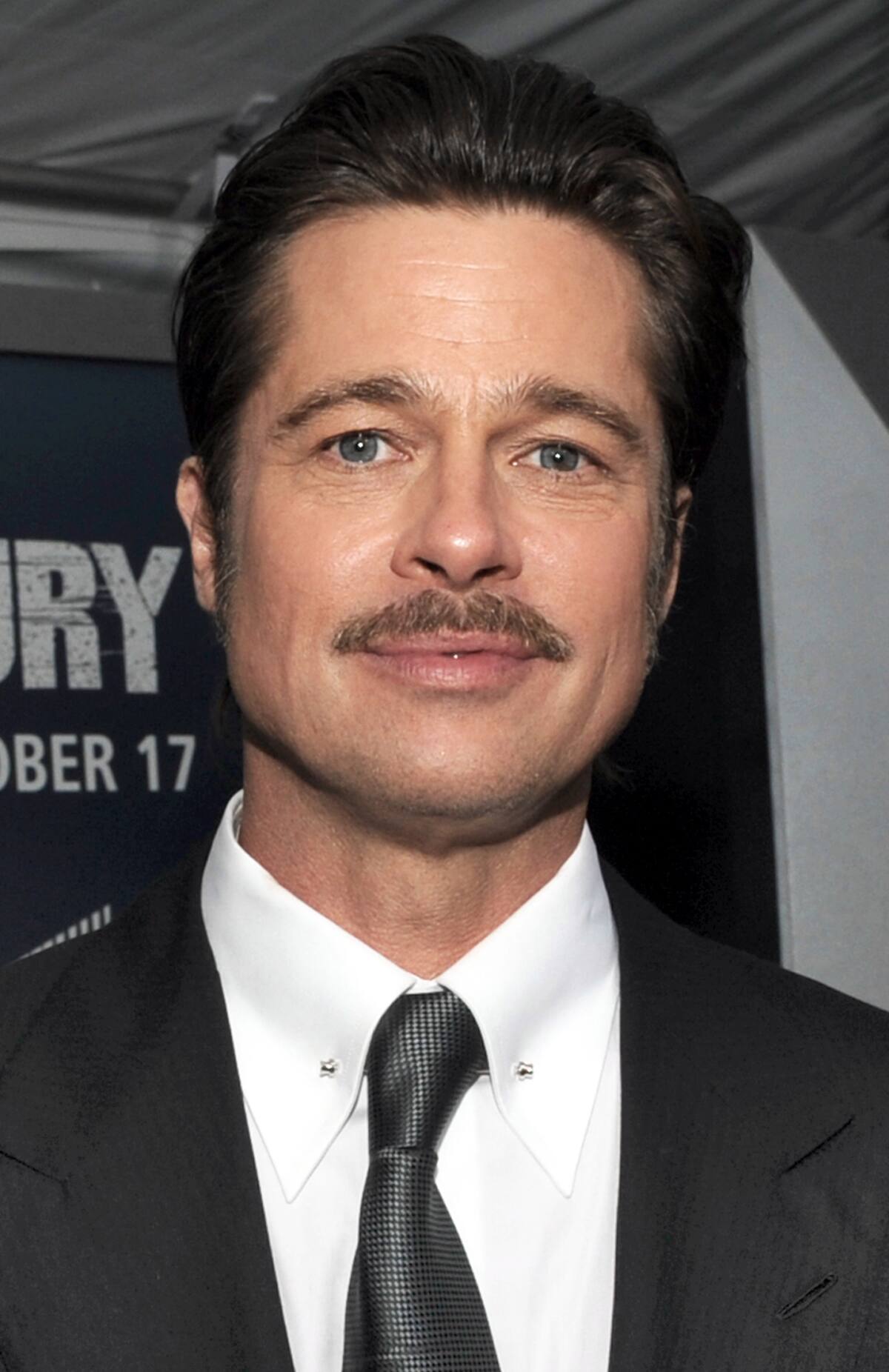 Actor Brad Pitt, the star of the movie, who plays the part of “Wardaddy/Don Collier”, gives interviews with the Mr. John Bradley and Lisa Fernandez of the Defense Media Activity on the “Red Carpet” during the world premiere of the movie Fury at the Newseum in Washington D.C. (Department of Defense photo by Marvin Lynchard)