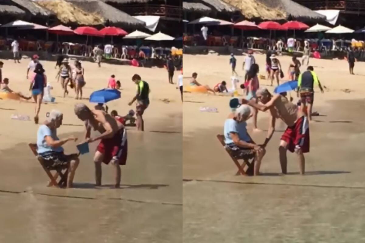 Abuelito baña a su esposa en la playa